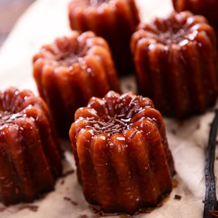 Caneles de bordeaux - traditional French sweet dessert on table